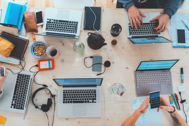 People sitting near a table with laptops-email segmentation