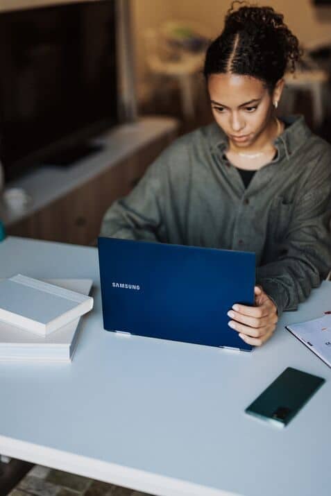 a woman looking at her laptop