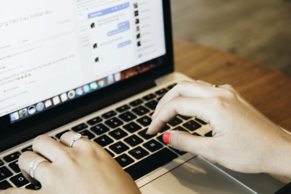 a woman typing on her laptop