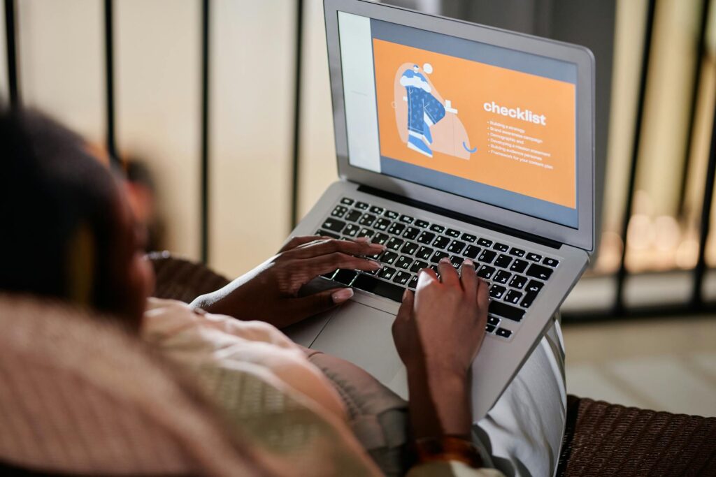 a person typing with laptop on her lap