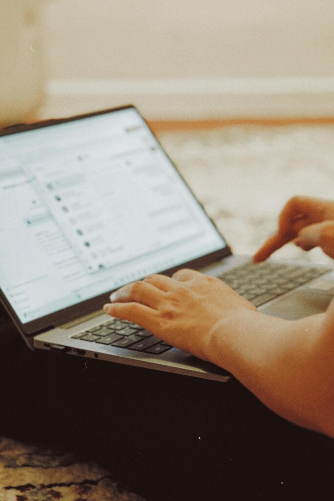 hand typing on a MacBook