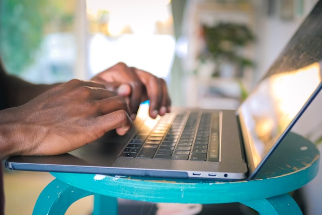 a man typing on a MacBook