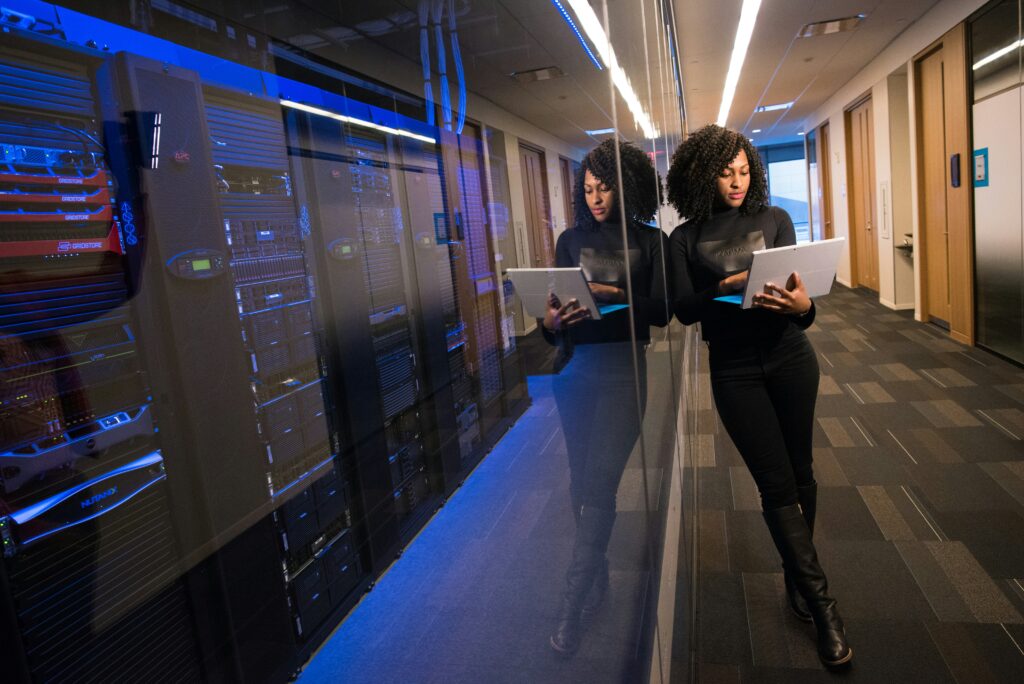 A woman standing with a laptop