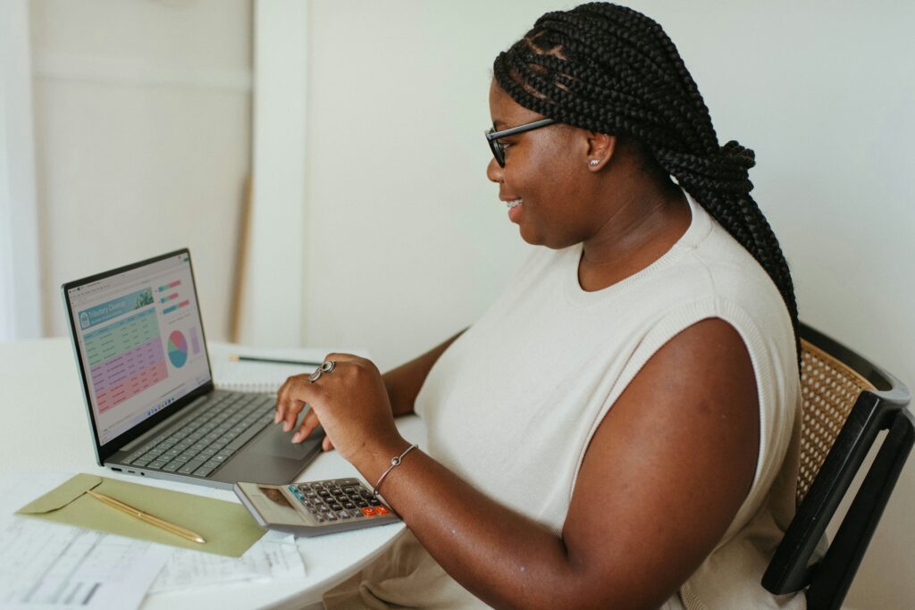  A woman sitting at a table with a laptop
