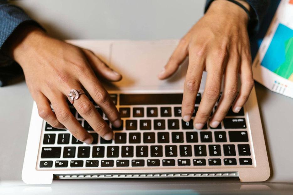 a person typing on a laptop